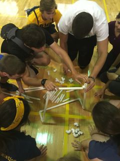 students building a structure and laughing