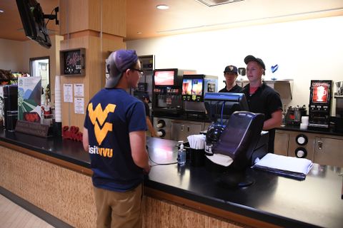 student checks out at dining hall