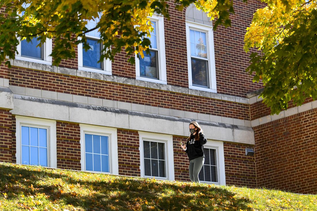 student walks in front of residence hall