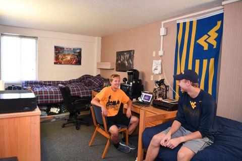 two male students talk in their room