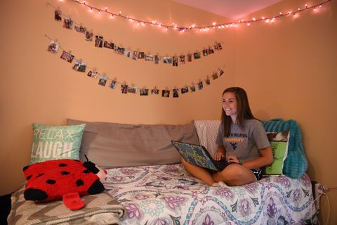 a student sitting on her bed